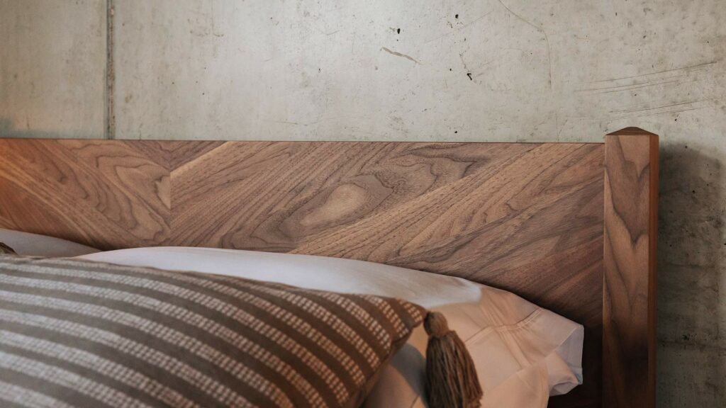 the Dalston bed has a chevron pattern to its headboard here it is shown in walnut wood