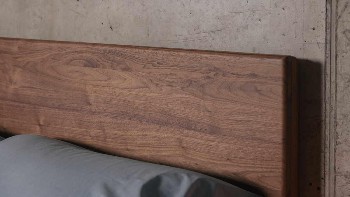 Walnut Chiswick bed with tall headboard shown close up