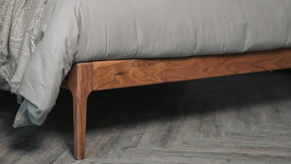 Chiswick a handmade solid wooden bed here made from walnut a close up of the foot end leg