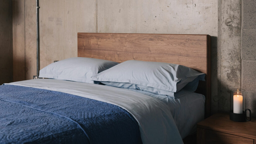 Pale blue Chambray bedding including sheets, pillowcases and duvet covers shown with a darker blue quilt