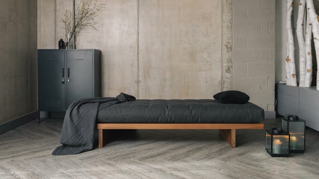 walnut daybed with dark grey mattress and organic cotton throw