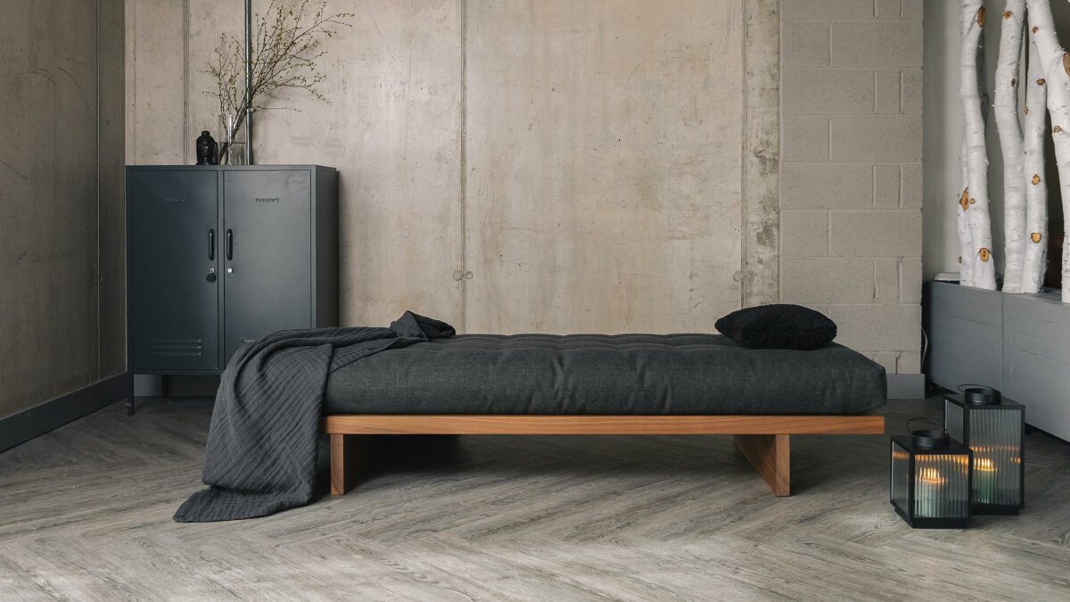 walnut daybed with dark grey mattress and organic cotton throw
