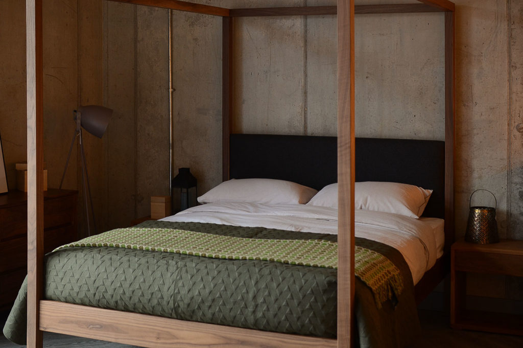 Autumnal bedroom with army green bedding, Walnut Highland 4 poster bed, and walnut bedside drawers