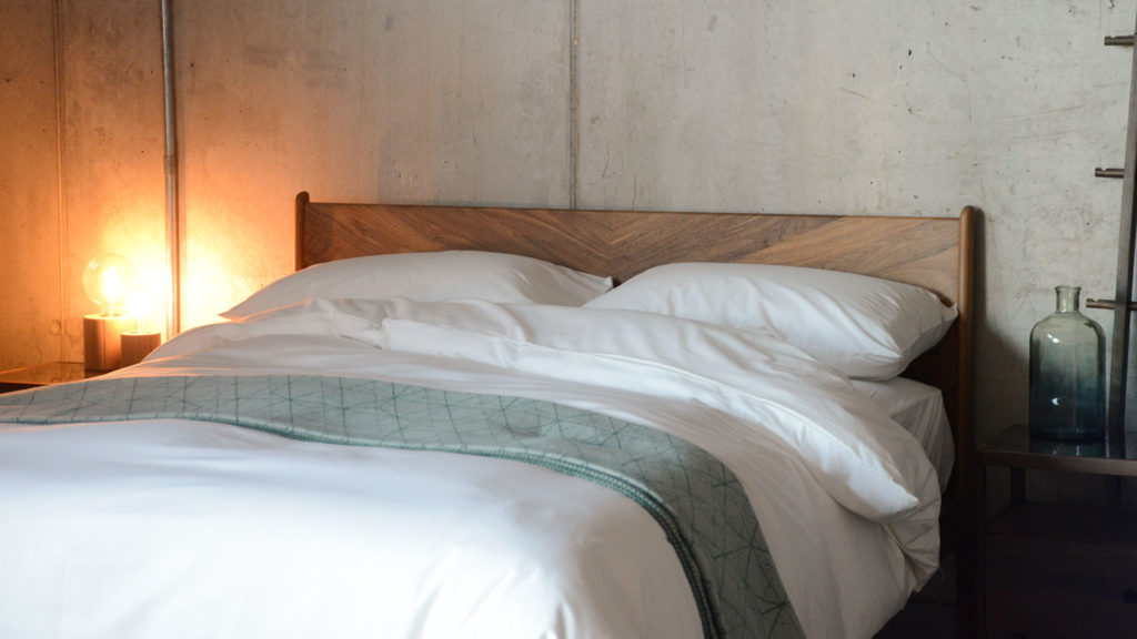 ivory organic cotton bedding shown on Hoxton bed with hand made solid wood herringbone headboard.