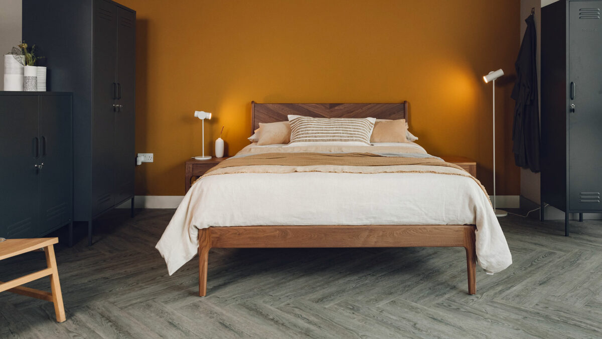 The Hoxton bed has a chevron pattern solid wood headboard here shown in walnut