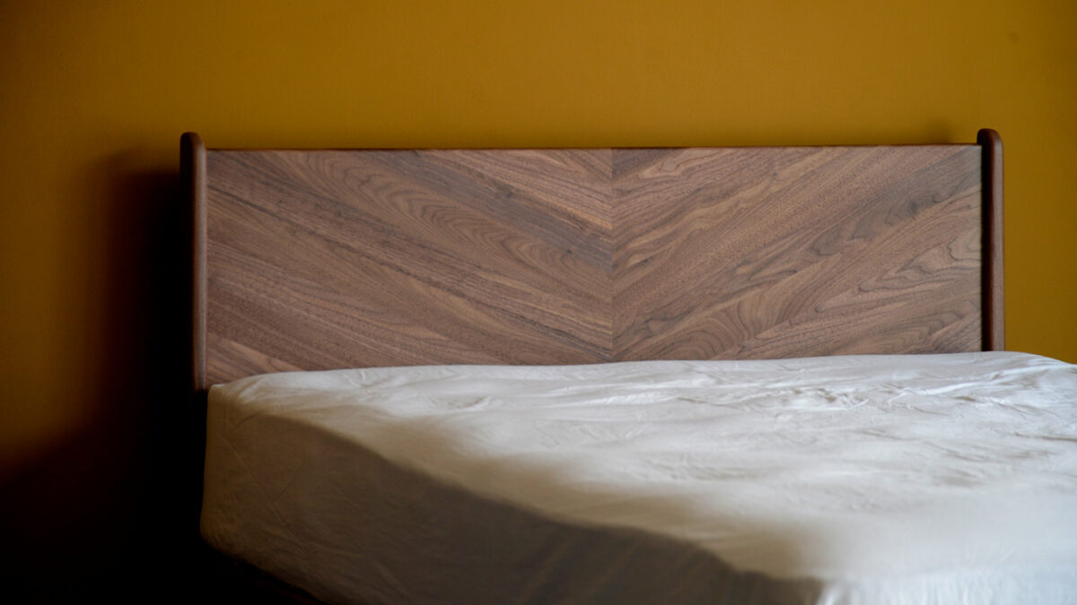 the Hoxton handcrafted solid wood bed with chevron pattern headboard here it is made in Walnut