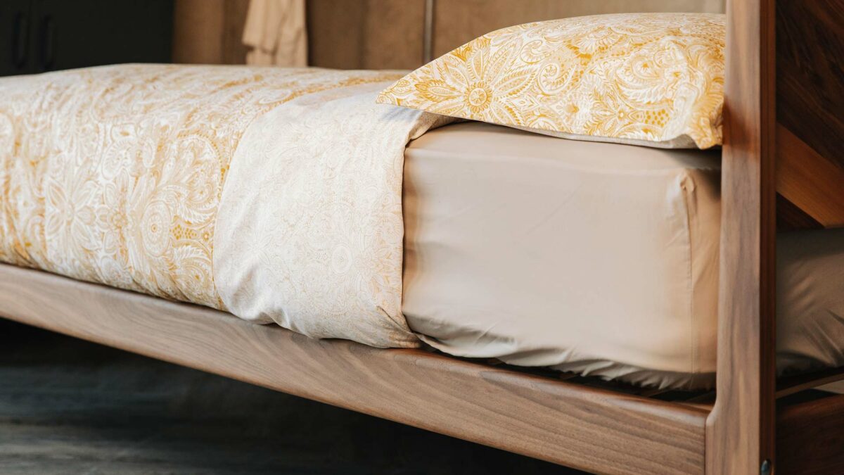 a closer view of the hand crafted headboard of the Hoxton in Walnut