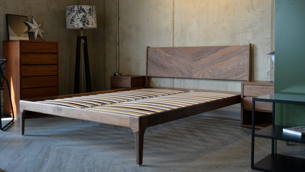 Our hand-made mid-century style wooden bedframe the Hoxton Bed with Chevron headboard, shown in Walnut.