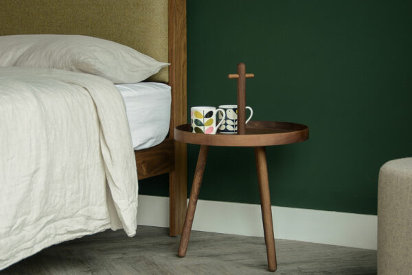 walnut wood tray table with handle used as bedside table