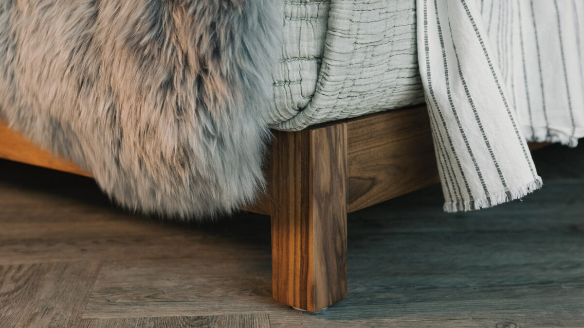 a closer look at the leg of a walnut wood Sonora bed