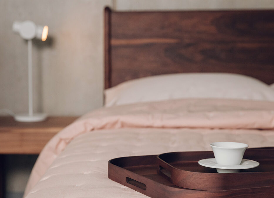 blush pink quilted cotton bedspread shown on a kingsize bed