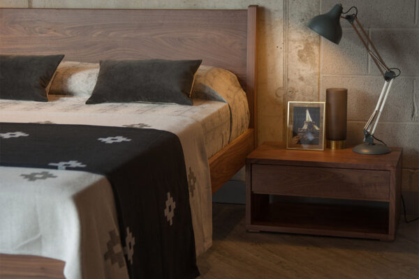 Low 1 drawer Cube bedside table shown with Zanskar wooden bed, all in Walnut wood.