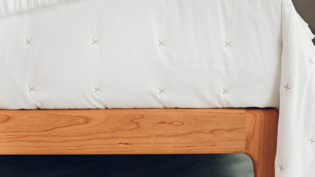 warm white cross stitch quilted cotton bedspread shown in close up