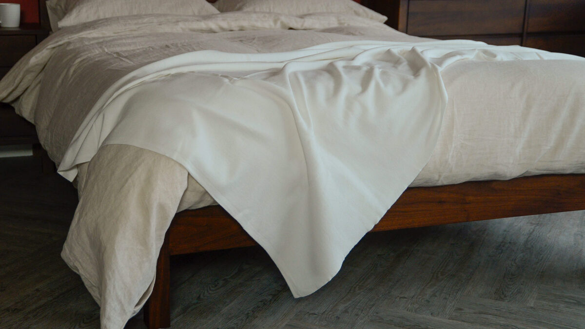 warm white soft fine knit blanket on bed