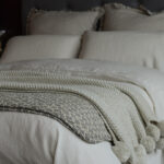washed vintage linen limestone quilted cotton thow knitted pompom throw