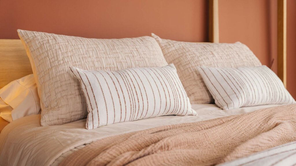white a deep red stripe cushions with blush bedding