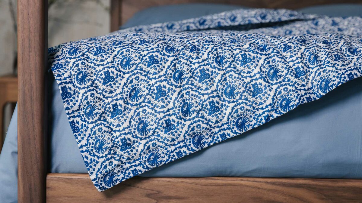white and blue printed quilt close up