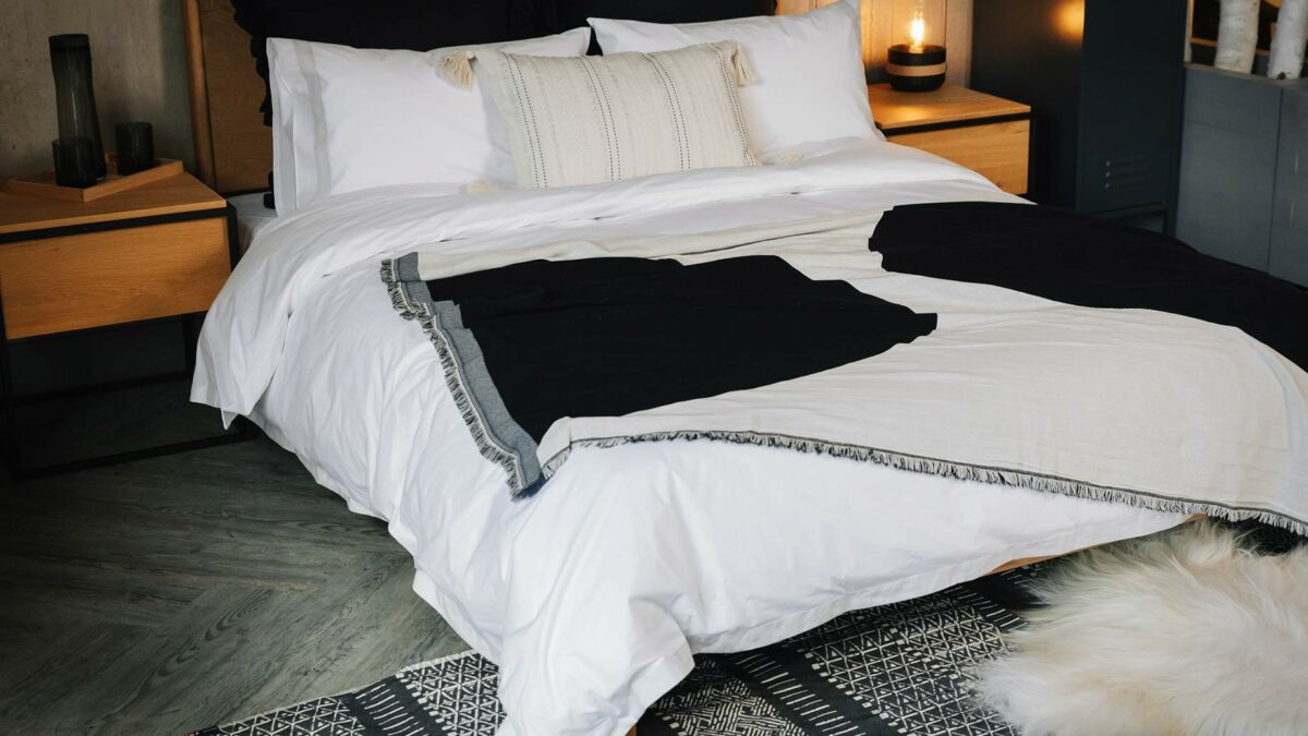 Monochrome bedroom look with ethnic style black and white printed cotton rug