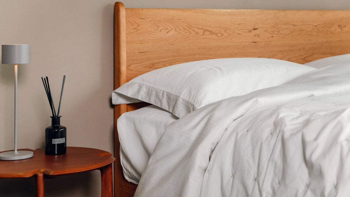 white and grey striped duvet set with oiled cherry bed