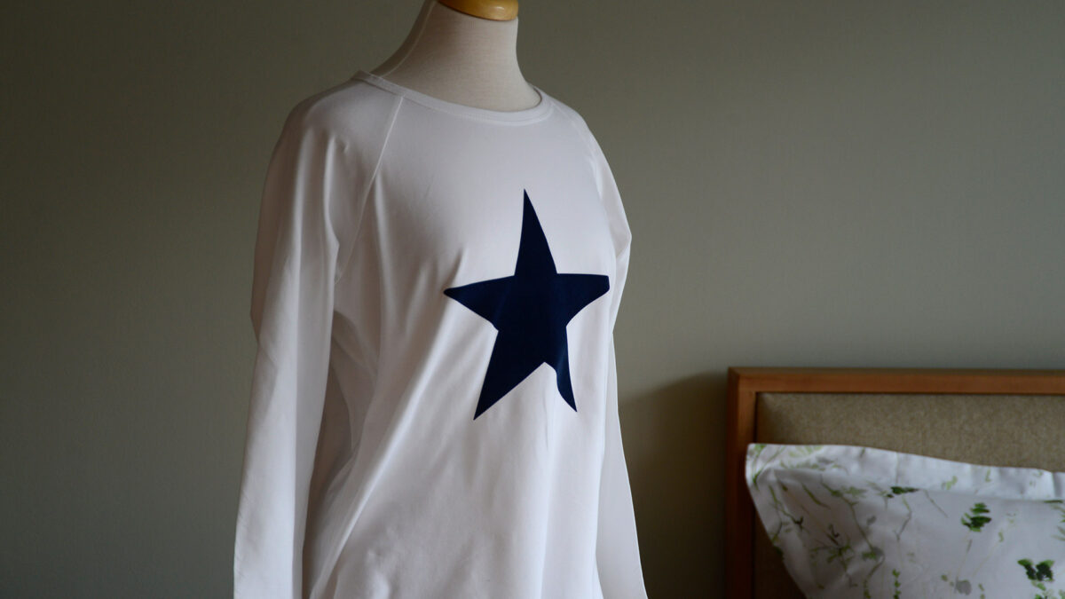 baseball style women's white long sleeve top with star print