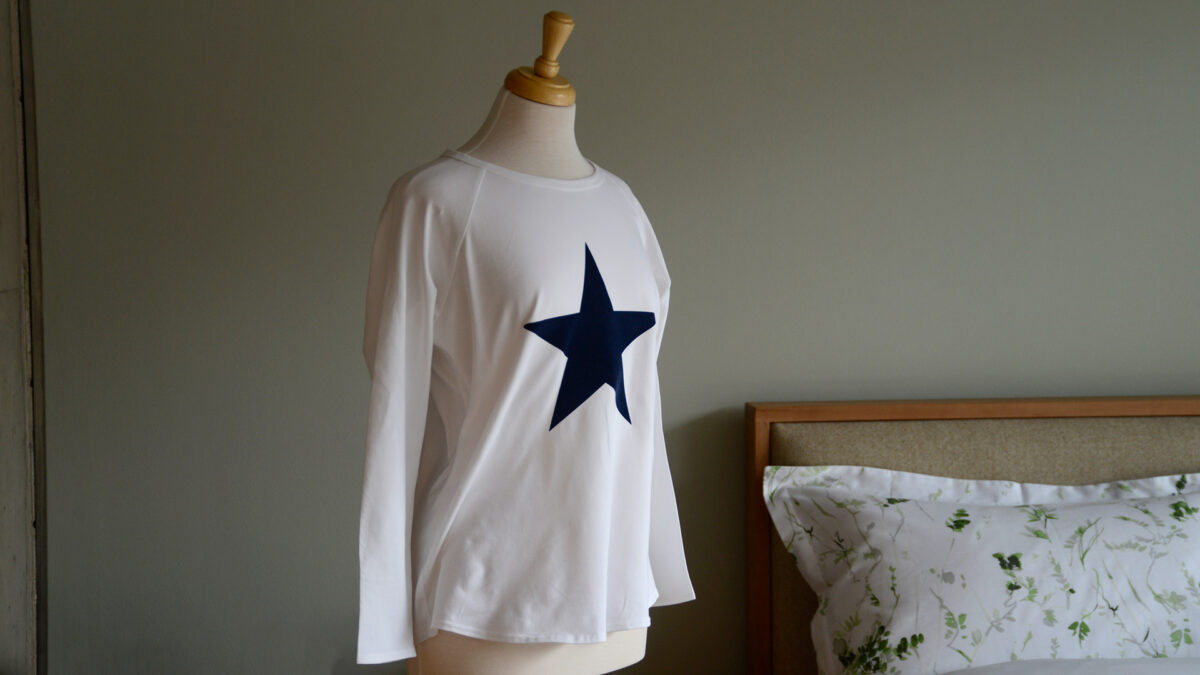 white women's long sleeve top with blue star