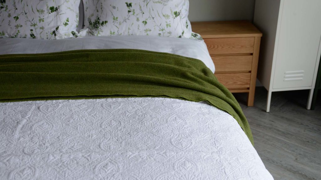 white embroidered bed cover