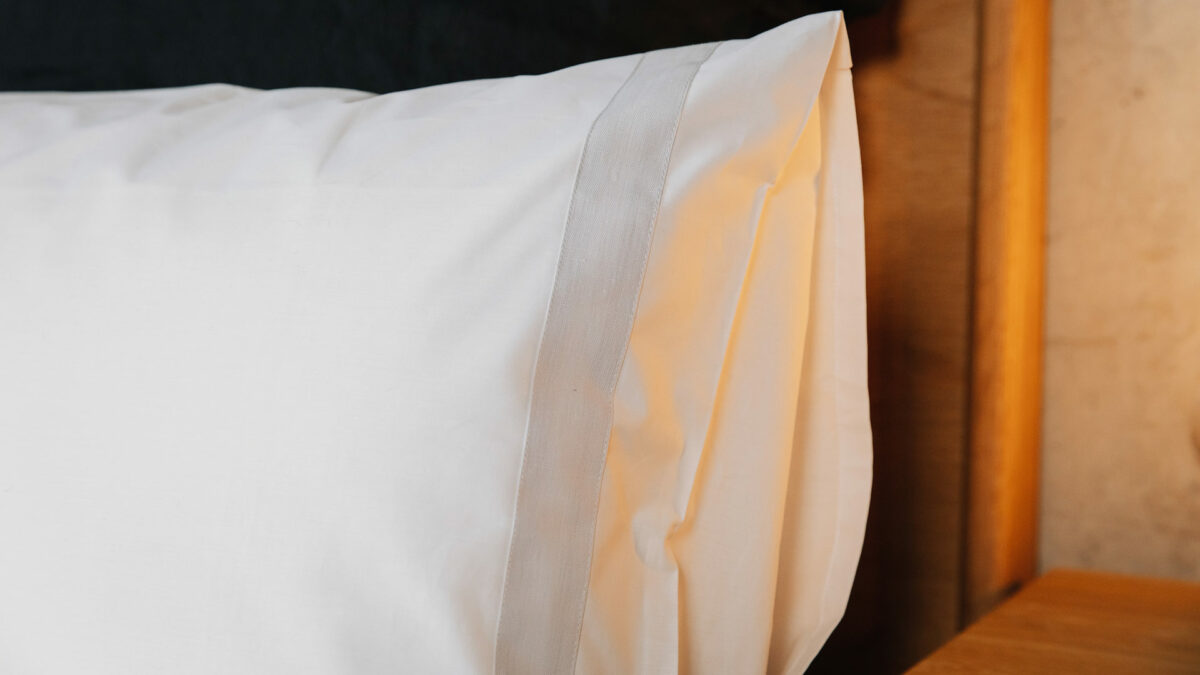 white cotton bedding with pale grey linen border pillowcase