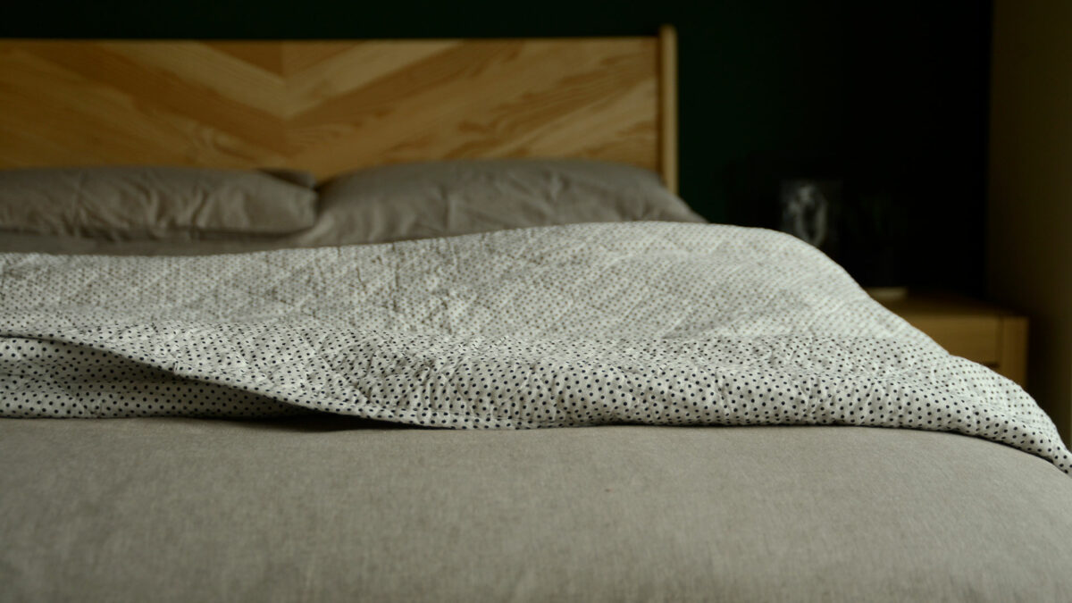 white cotton quilt with black dots