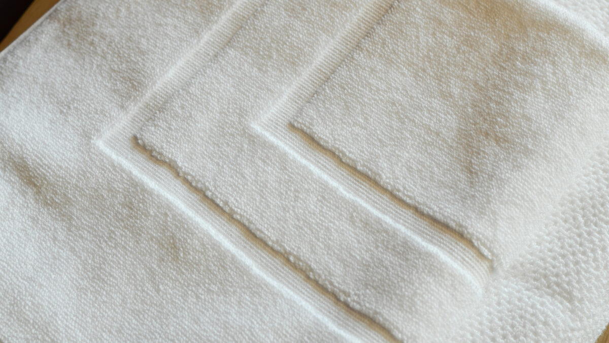 white cotton towels bath mats