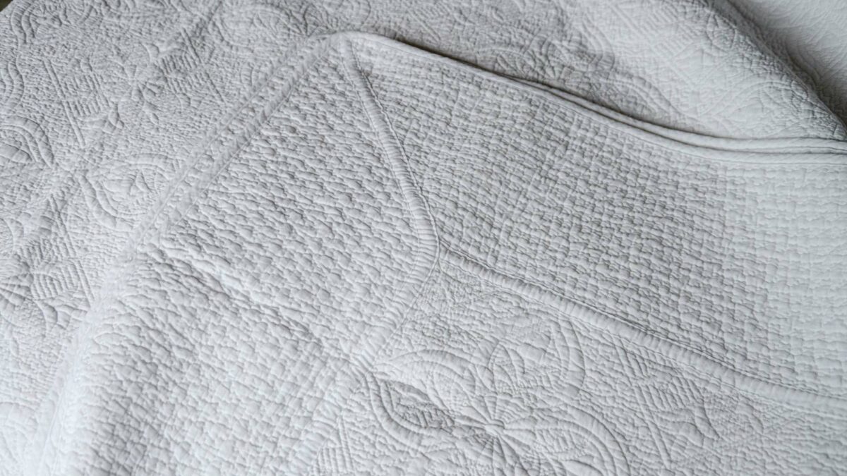 classic white embroidered and lightly quilted cotton bedspread