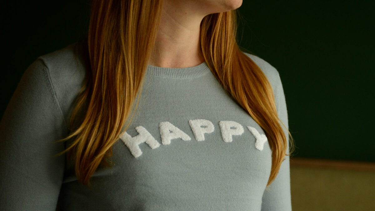 white happy motif on duck egg blue jumper