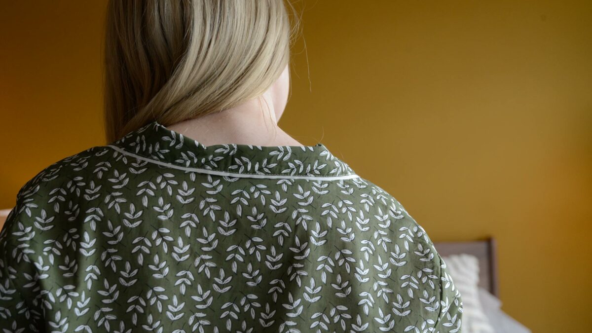 lightweight cotton pjs with a block print leaf design in olive green and white and shown from the back