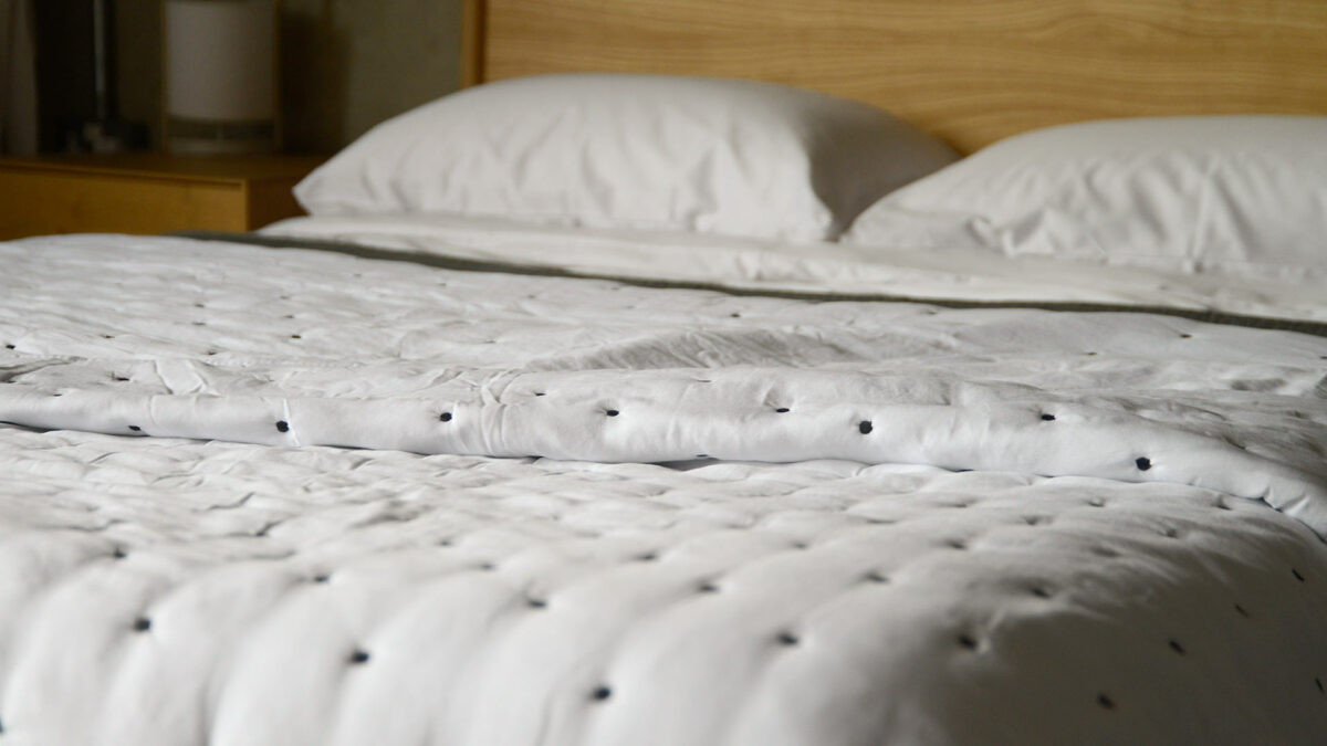 white quilt with ink embroidery