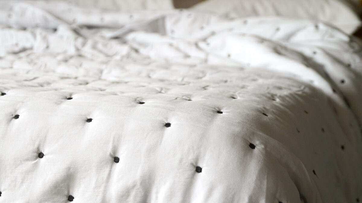 white quilted bedspread with black looking embroidery 1
