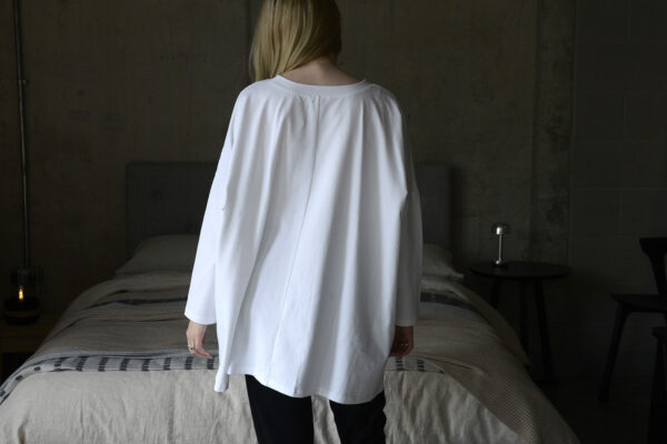 loose fit long sleeve white Tee shirt shown from the back