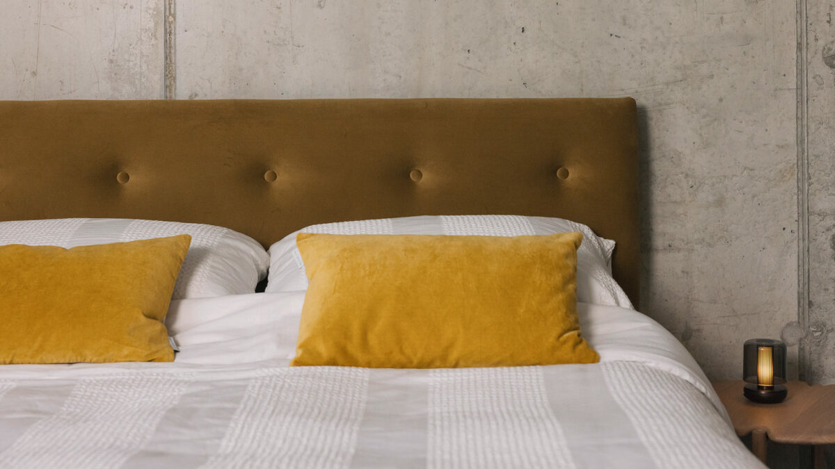 white waffle stripe bedding with eco velvet headboard and firefly lamp