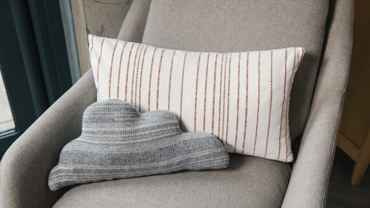 cloud shaped stripey knitted cushion in grey