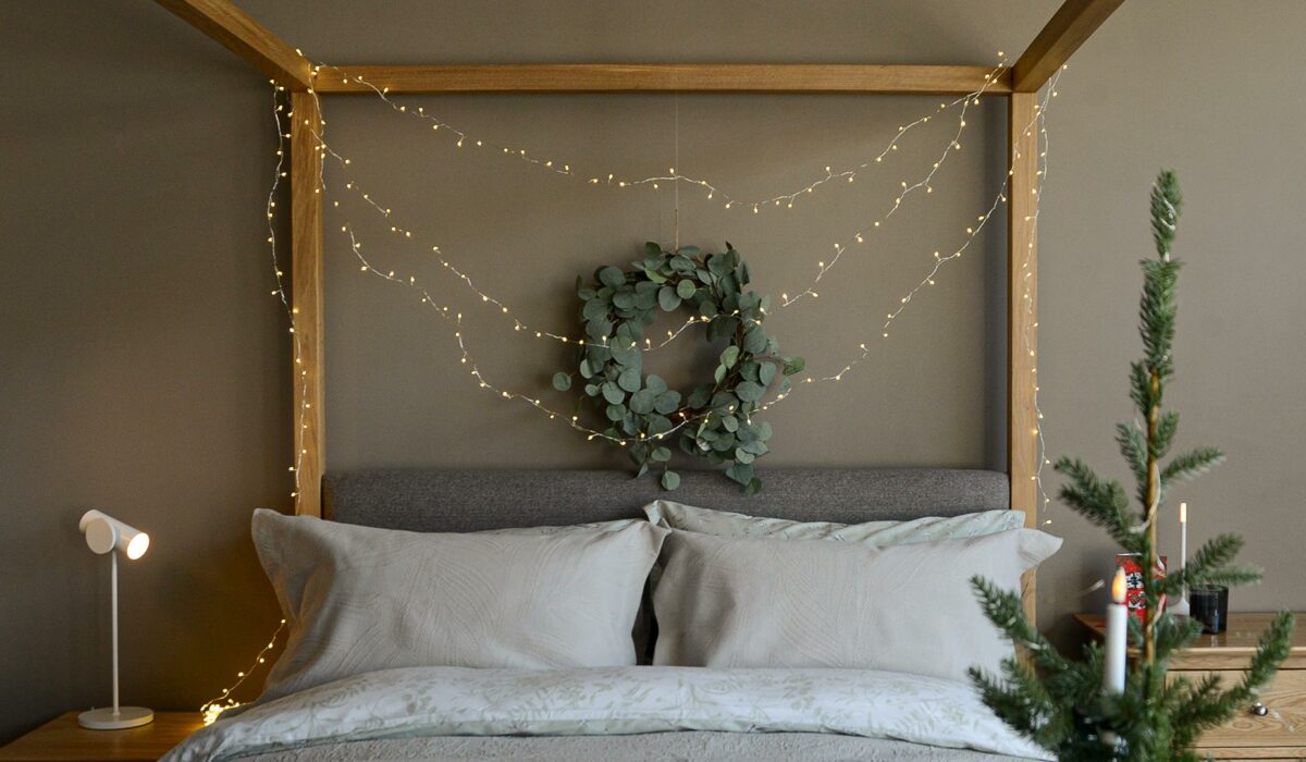 christmas bedroom with LED string lights and eucalyptus wreath