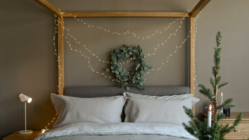 christmas bedroom with LED string lights and eucalyptus wreath