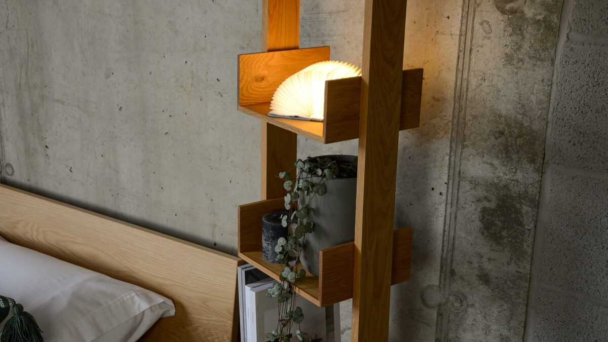 side angle view of the freestanding oak bookshelf shown in use