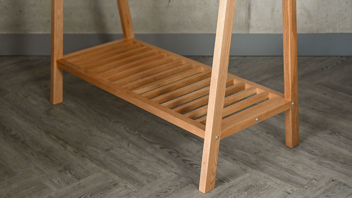 Image showing the lower shelf of the Freestanding Solid Oak Clothes Rail. The lower shelf is slatted and runs the total width of the rail.