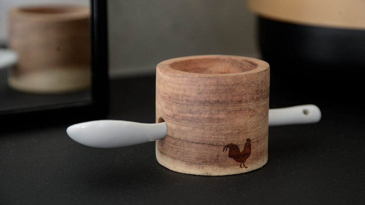 wooden egg cup and porcelain spoon