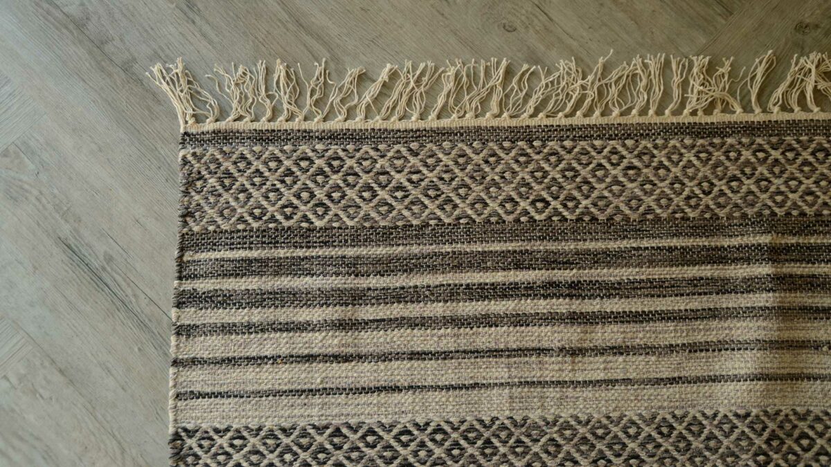 woven rug with cream fringe