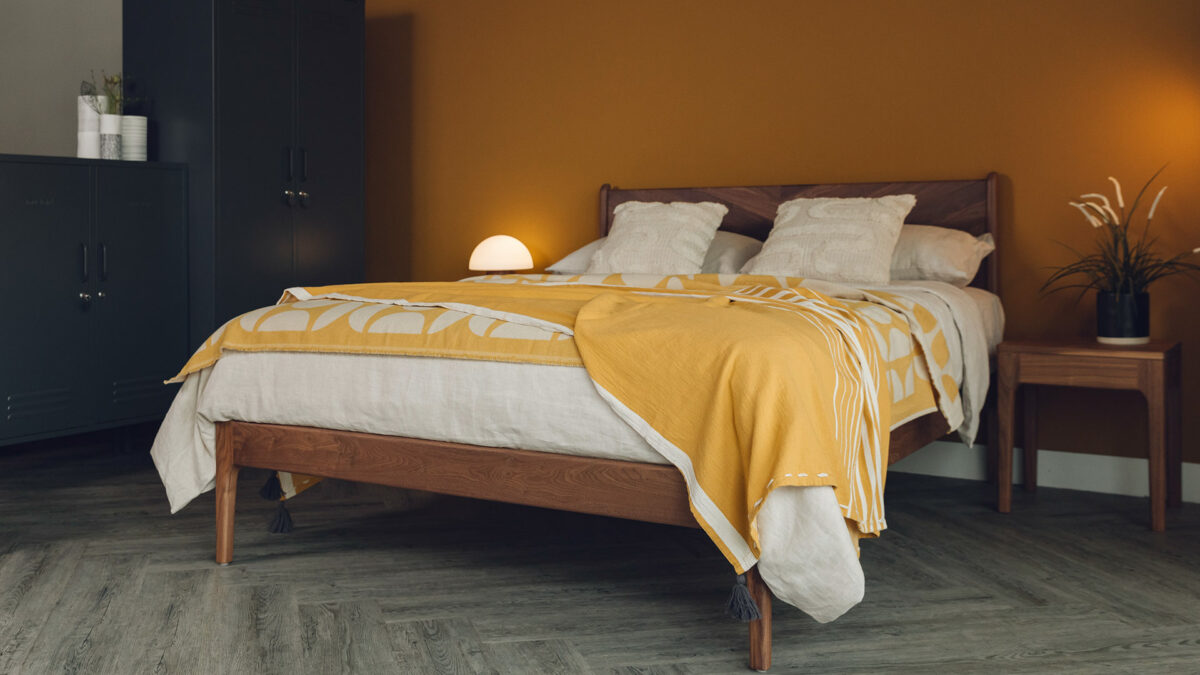 yellow and ecru bedding on walnut bed