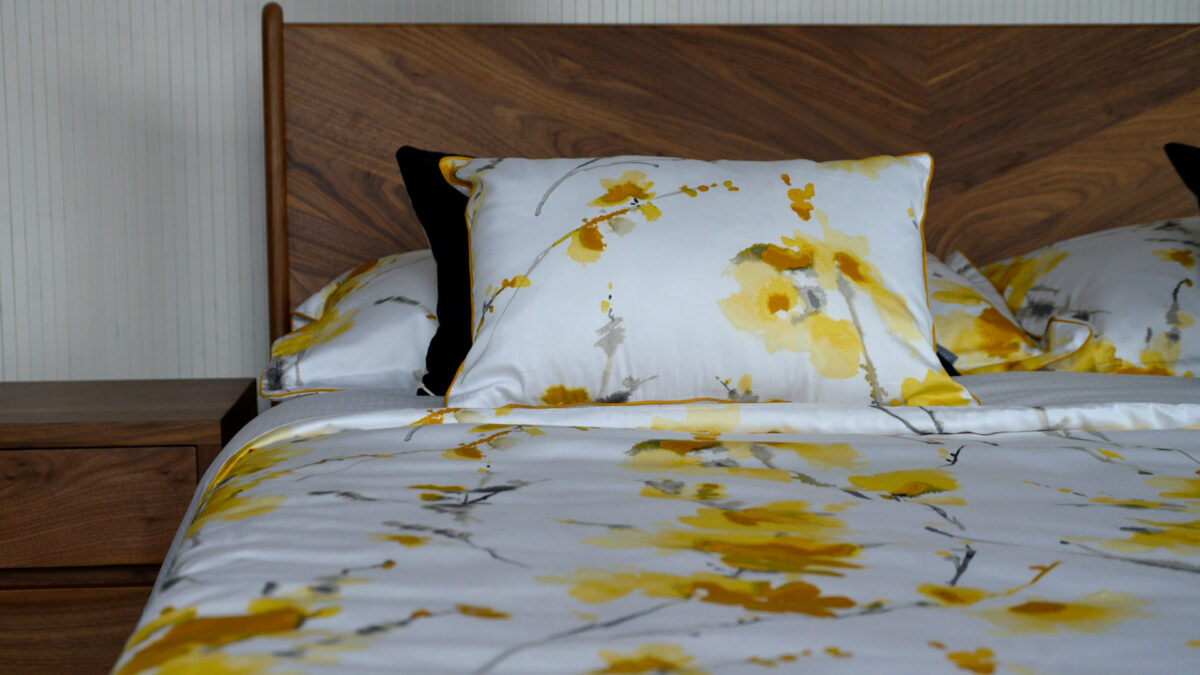 yellow and ochre flower print cushions and bedding