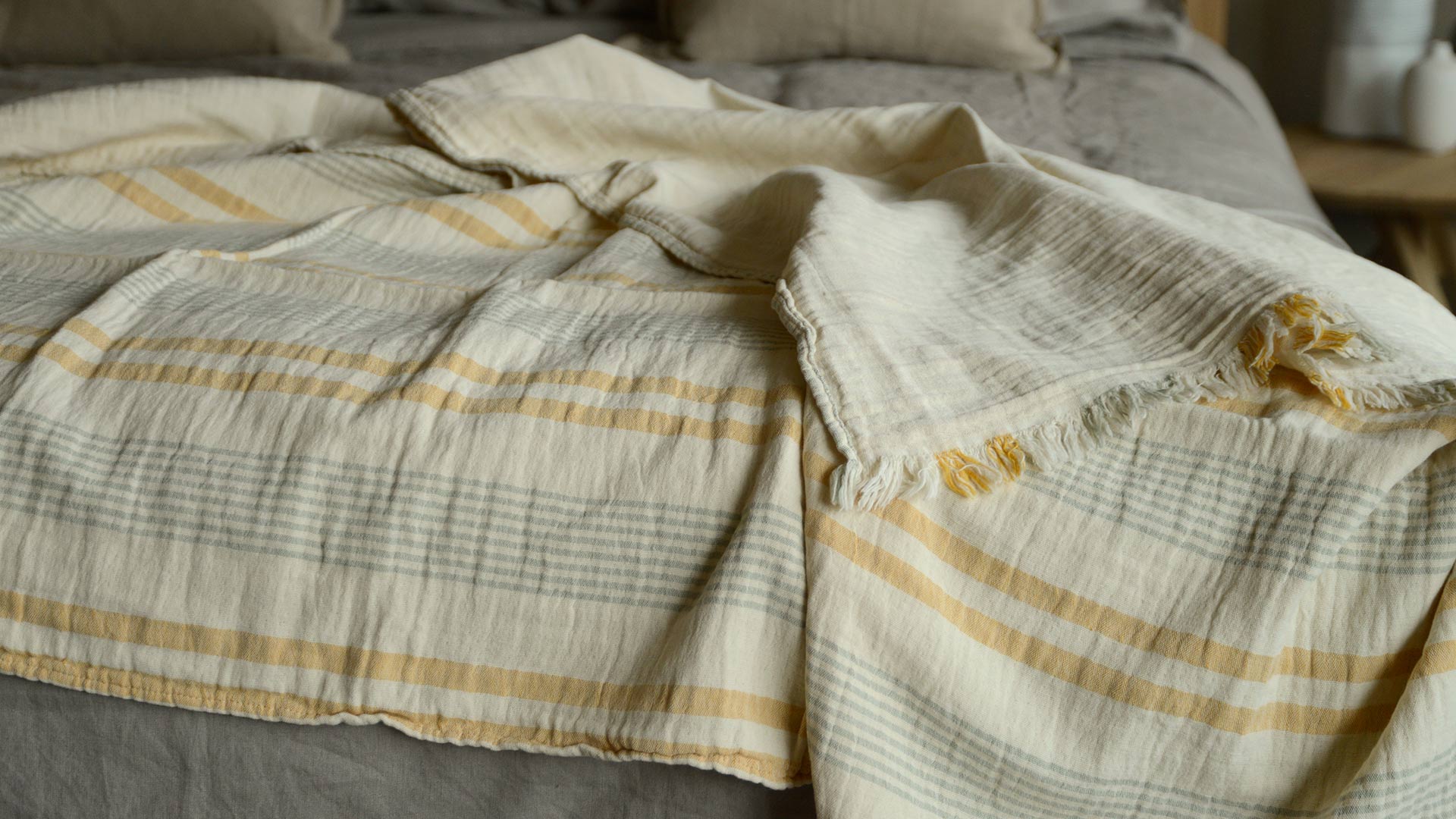 lightweight cotton throw in ivory with pale sage and yellow stripes